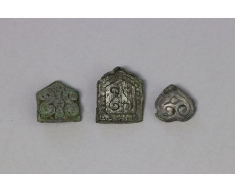 A Saxon silver belt mount group, 7th-8th century AD. The belt mounts comprising: one heart-shaped with opposed scroll detail,