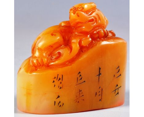 A 19th Century Chinese hand carved Shoushan stone wax seal depicting a Foo Dog modelled reclined with calligraphy to the side