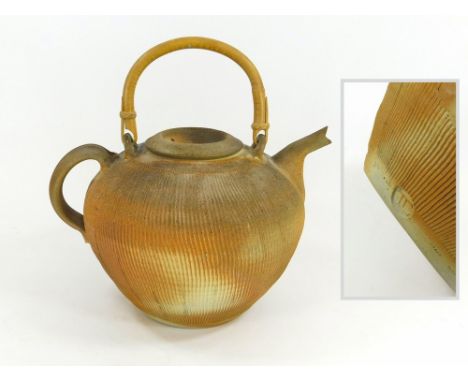 THIÉBAUT CHAGUÉ. A large, gallon size, cane handled teapot with fluted decoration by Thiebaut Chague. Impressed monogram 'TC'