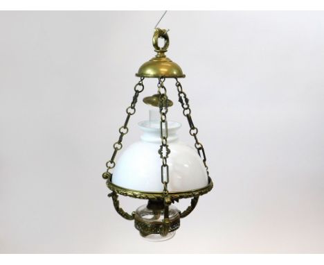 HANGING OIL LAMP. A hanging oil lamp with clear glass fount & opaque white shade. The frame in heavy cast brass stamped F & S