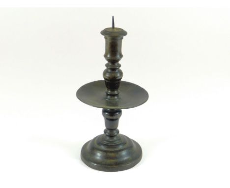 PRICKET CANDLESTICK. A late 17th century Heemskerk cast brass candlestick. The socket with two filled holes & fitted with an 