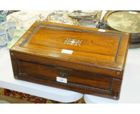 A 19th century rosewood writing slope, the lid with mother-of-pearl decoration, 40cm wide, 14cm high, 25cm deep.