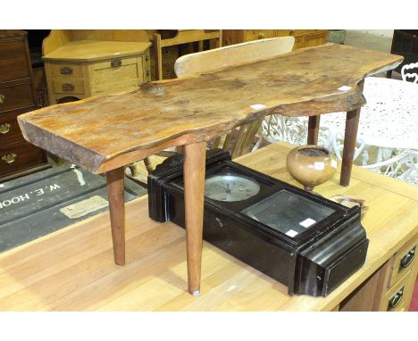 Reynolds of Ludlow, a naturalistic yew wood coffee table on turned legs, 107cm long, label to underside, a wooden wall clock 