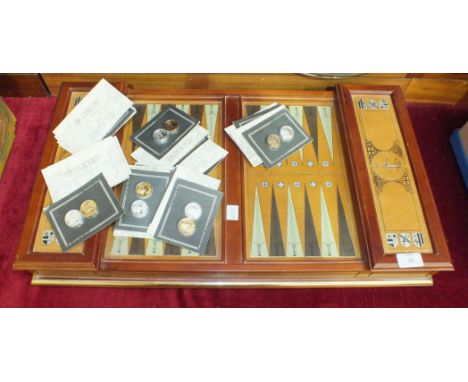 A Franklin Mint 'The Excalibur' backgammon set, comprising playing board, thirty playing pieces, (fifteen gold-plated, fiftee