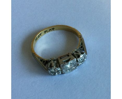 A good Art Deco diamond three stone ring in 18 carat gold and platinum. Approx. 3 grams. Est. £100 - £150.