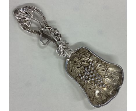 A good silver caddy spoon with vine decoration. Birmingham. By BG. Approx. 25 grams. Est. £30 - £40.