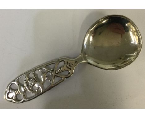 A silver caddy spoon pierced with horse decoration. Approx. 22 grams. Est. £20 - £30.