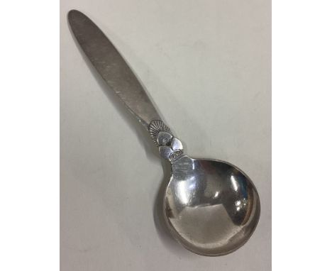 GEORG JENSEN: A large caddy spoon of typical form with tapering handle. Approx. 34 grams. Est. £40 - £60.