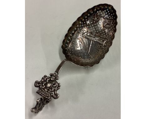 OF NAUTICAL INTEREST: A chased Dutch silver caddy spoon with pierced decoration. Marked 930. Approx. 37 grams. Est. £30 - £40