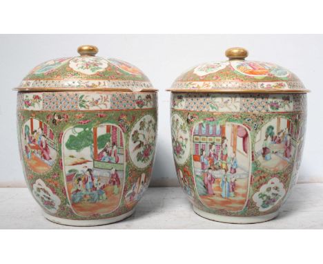 A pair of 19th century Chinese famille rose porcelain jars and covers, decorated with enamel panels of figures on floral grou