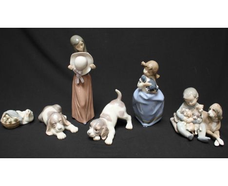SECTION 3.  Five various Lladro figures including a child playing with puppies and a lady holding a hat, together with a sing