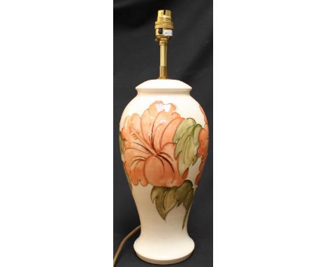 A large Moorcroft Hibiscus pattern tube lined pottery table lamp, lacking shade. Body 30 cm high.