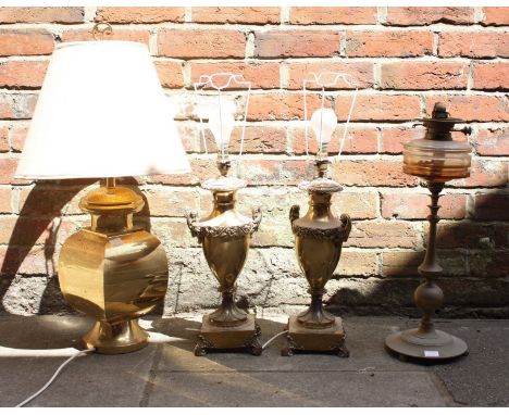 A pair of lacquered brass urn lamps, together with another lacquered brass lamp and oil lamp base (4)