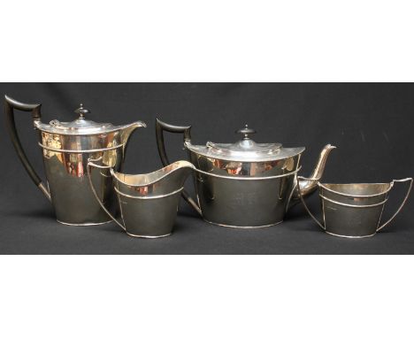 A George V silver four piece tea service, hallmarked Sheffield 1911, comprising teapot, hot water jug, milk jug and sugar bow