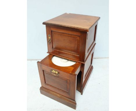 An Edwardian stained bedside cupboard / commode, the top with panel door and sliding commode section below.