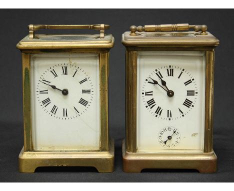 Two brass carriage clocks with white enamel dials.