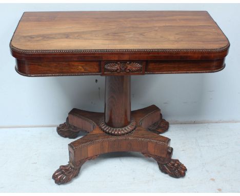 A Regency rosewood folding card table (possibly Irish), the hinged top opening to reveal a green playing baize, moulded detai