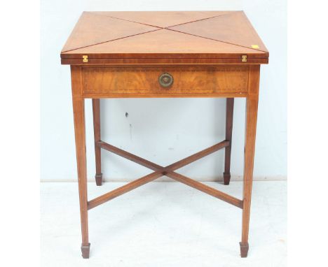 An Edwardian inlaid mahogany folding card table, the square top cut into four triangular hinged sections, folding to reveal a