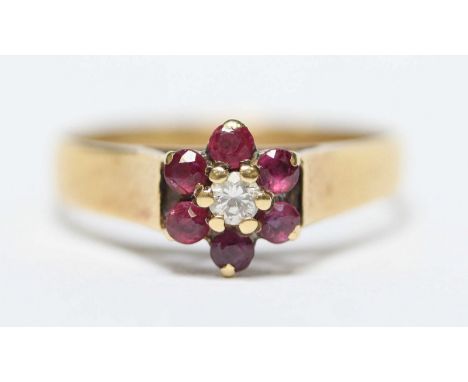 An 18ct gold, diamond and ruby daisy cluster ring. 3.8 grams. Size Q.