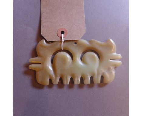 A Chinese carved jade pendant of comb form