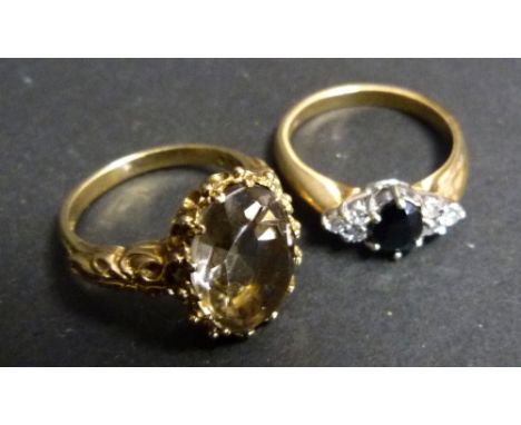 A 9ct. Yellow Gold Dress Ring Set With Oval Citrine Within A Pierced Setting, together with a 9ct. yellow gold dress ring 