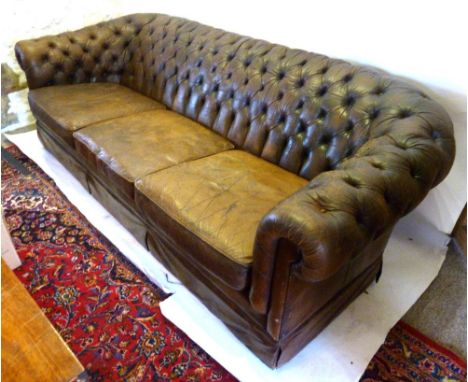 A Brown Leather Chesterfield Sofa with a button upholstered back and arms, 221 cms long