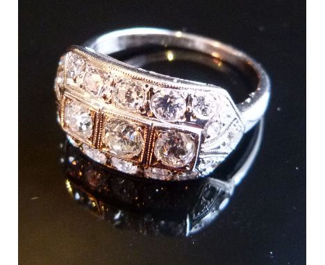 An 18ct. White Gold Art Deco Style Diamond Ring, set with three central diamonds surrounded by diamonds within a pierced sett