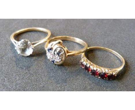 A 9ct. Gold Five Stone Garnet Band Ring together with two other 9ct. gold rings