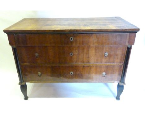 A 19th Century French Walnut Commode Chest with Three Drawers and Brass Lion Ring Handles flanked by ebonised gilt metal moun