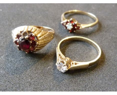 A 9ct. Gold Garnet Cluster Ring together with a 9ct. gold solitaire ring and another cluster ring