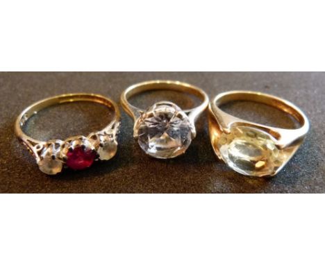 A 9ct gold three stone ring together with two similar 9ct gold solitaire rings