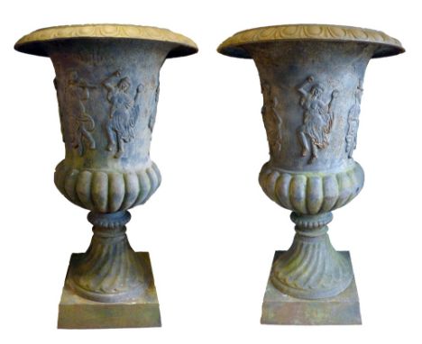 A Pair of 19th Century Very Large Cast Iron Urns, each decorated in relief with classical figures dancing and playing musical
