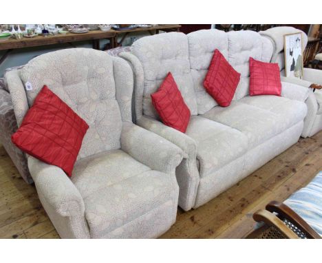 Three seater wing back settee and chair in light foliate pattern fabric 