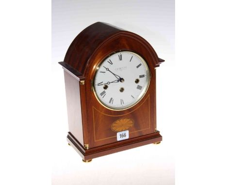Comitti inlaid mahogany striking mantel clock having quarter columns and on brass bun feet