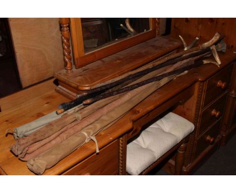 Collection of vintage fishing rods and horn handled sticks.