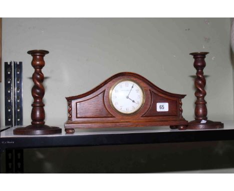 1920's oak mantel clock and a pair of oak twist mantel sticks.