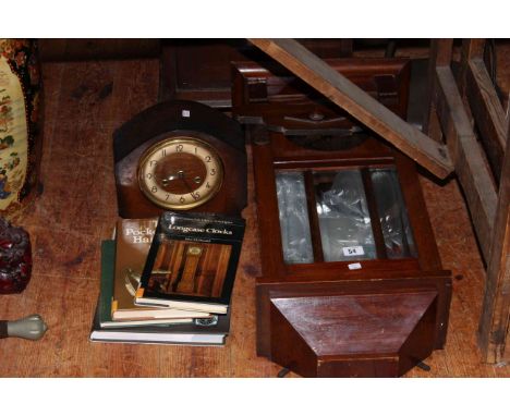 Eight day mantel clock, seven day wall clock and four books.