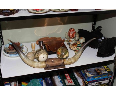 Shelf of collectables including carved eagle, mounted horns, hand-painted ostrich eggs, onyx goblets, three plaques, plates, 