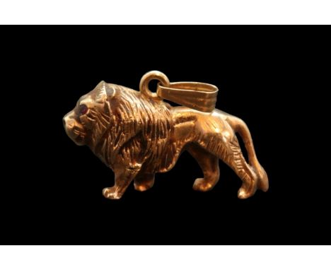 Heavy 9ct Gold Lion Pendant with  Rose Cut Ruby eyes and hanging bale. Stamped 375 Hallmark to base. 20.3g total weight, 35mm