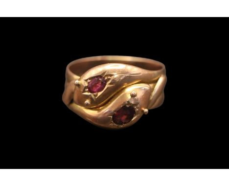 A Victorian double serpent head 9ct gold and Ruby ring. Set with two Oval facetted Rubies estimated at 0.25ct each. Size U, 5