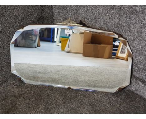 An art deco bevelled frameless mirror 69cm wide.