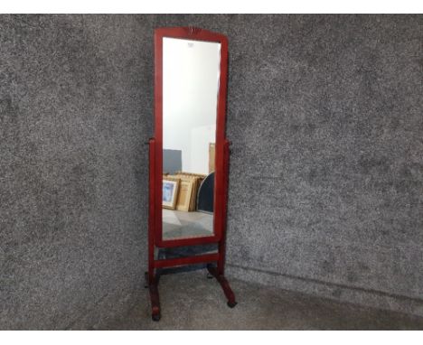 A modern cheval mirror raised on castors.