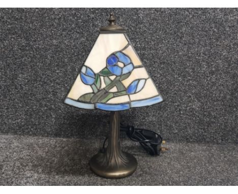 Metal based table lamp with tiffany style shade