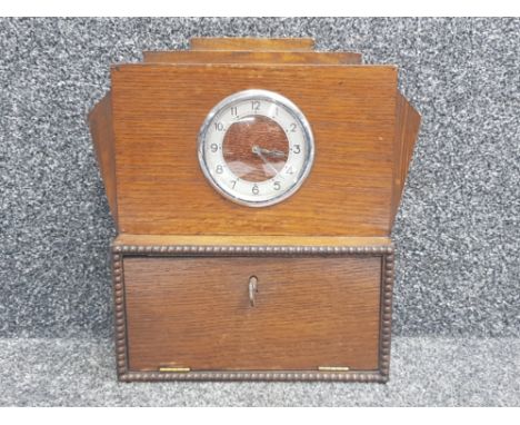 Oak Art Deco clock with storage section beneath, with key
