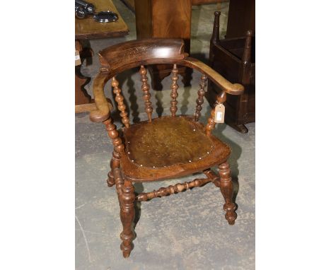 A 19th Century elm and beech wood smokers bow elbow chairWith bobbin turned spindles above a shaped seat applied with a drill