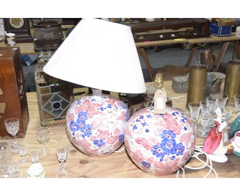 A pair of Chinese ceramic lamp basesThe bulbous form bases with all over pink and blue floral design picked out in gilt highl