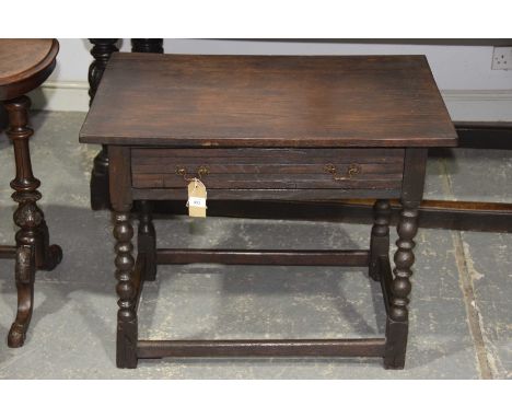 An 18th Century and later oak side tableHaving a rectangular top above a single frieze drawer raised upon bobbin turned legs 