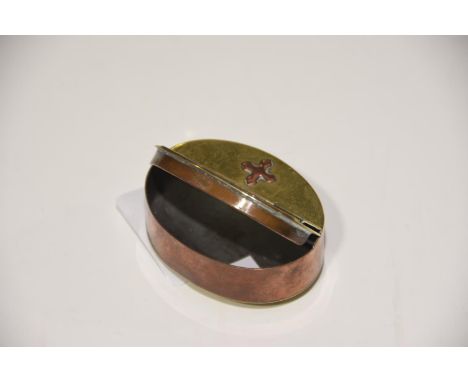 A brass and copper oval snuff box The snuff box with hinged cover, the brass domed top with copper embossed star design, with