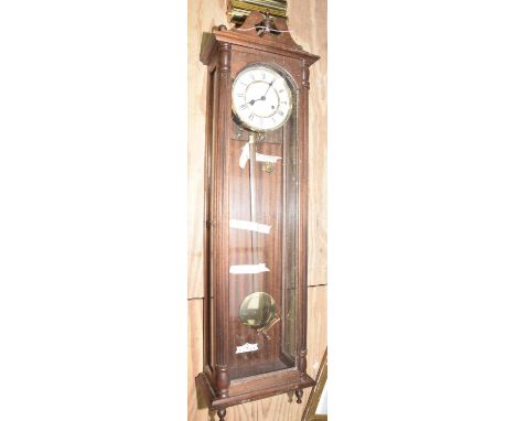 A walnut cased German Vienna style wall clock, 20th CenturyHaving a pediment and turned finials above a 16cm enameled white d
