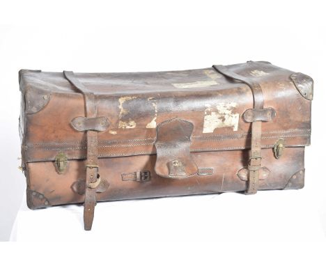 An impressive early 20th Century leather travel trunkThe substantial trunk fitted with two leather straps and side handles al